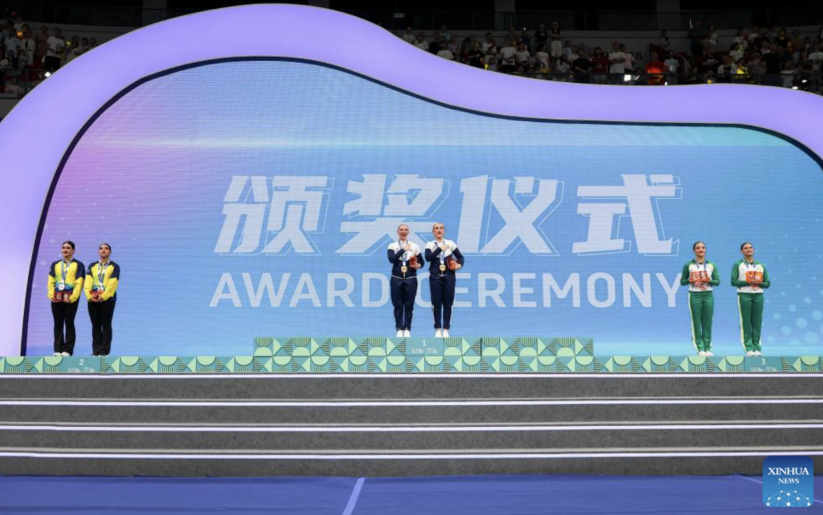 Silver medalists Jennifer Garcia/Fabiana Velez of Ecuador, gold medalists Sydney Martin/Allison Hoeft of the United States and bronze medalists Shayla Myerscough/Emily Growdon of Australia (L to R) pose during the awarding ceremony for the Cheerleading Pom Doubles Final at The World Games 2025 in Chengdu, southwest China's Sichuan Province, Aug. 16, 2025. (Xinhua/Liang Xu)